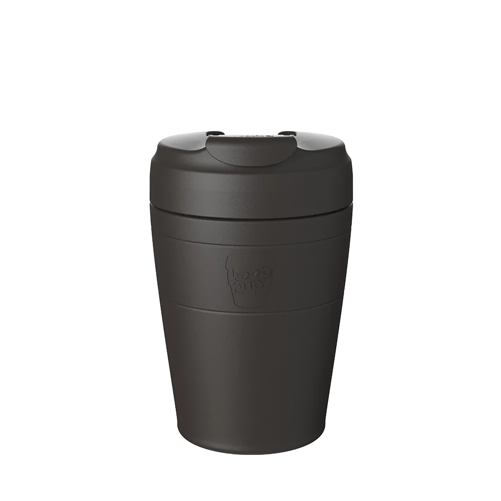 KeepCup Commuter M 12oz in Black, shown in a front-facing studio shot against a white background, featuring the embossed KeepCup logo on the black and a matching flip-top lid.