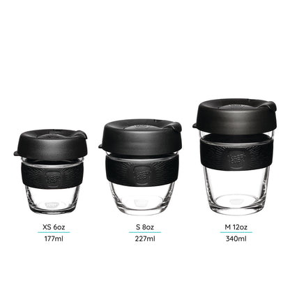 Three KeepCup Reusable Glass cups with lids of different sized cups xs - s -m on a white background