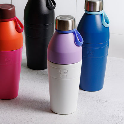 Four colourful KeepCup water bottles on a light surface.