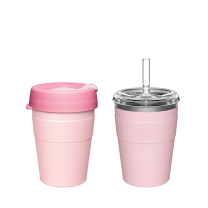 Two pink reusable coffee cups - one collapsible travel mug with lid and one insulated tumbler with straw and clear lid
