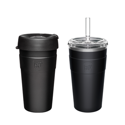Two black KeepCup reusable coffee cups - one with standard lid, one with clear straw lid and glass straw