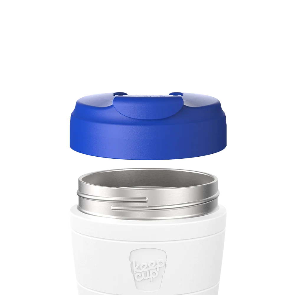 Electric Blue Commuter Flip Lid shown hovering above a white KeepCup with stainless steel rim, demonstrating how the lid attaches to the cup in an exploded product view.