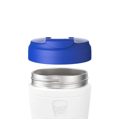 Electric Blue Commuter Flip Lid shown hovering above a white KeepCup with stainless steel rim, demonstrating how the lid attaches to the cup in an exploded product view.