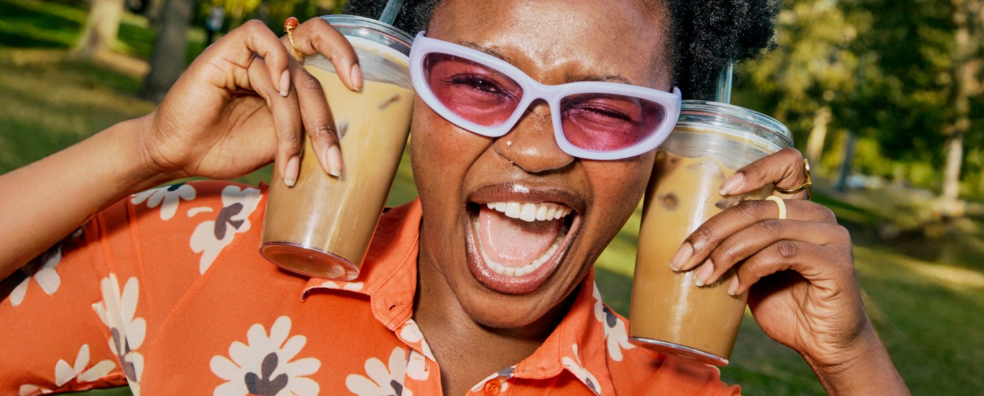Woman holding KeepCup Cold Cup Original with coffee straw