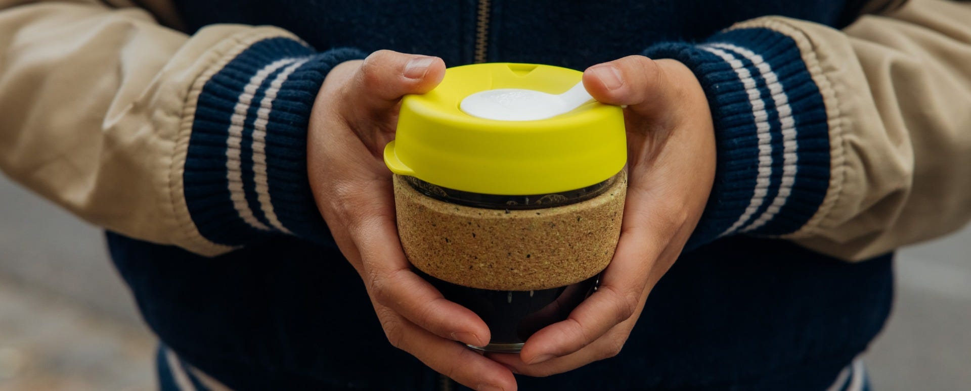 Woman holding KeepCup Brew Cork Ace 8oz with coffee